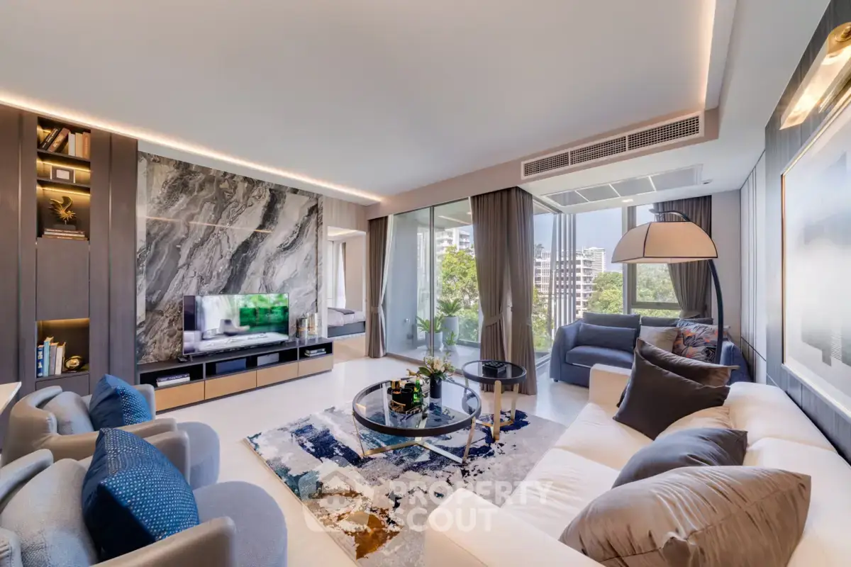 Luxurious modern living room with elegant decor and large windows offering a stunning city view.