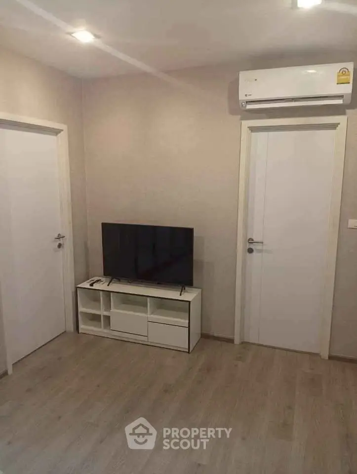 Modern living room with air conditioning and sleek TV setup, perfect for cozy relaxation.