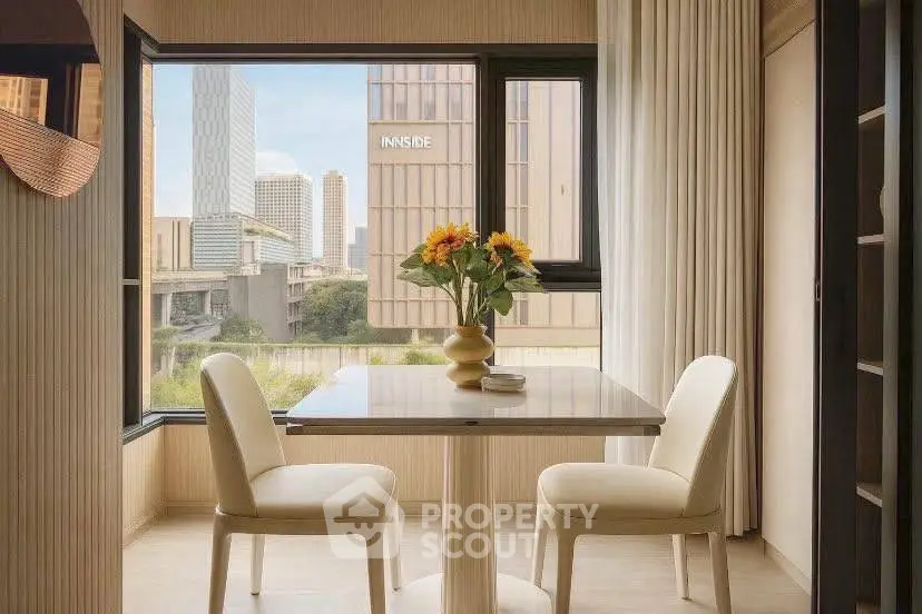 Elegant dining area with city view, featuring a stylish table and chairs, perfect for urban living.