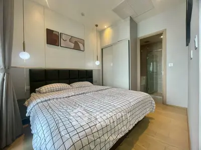 Modern bedroom with stylish decor and ensuite bathroom in luxury apartment