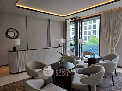 Elegant modern living room with stylish furniture and large windows offering a city view.