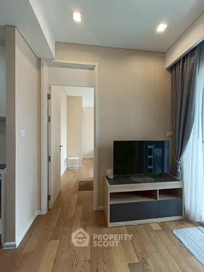 Modern living room with wooden flooring and natural light
