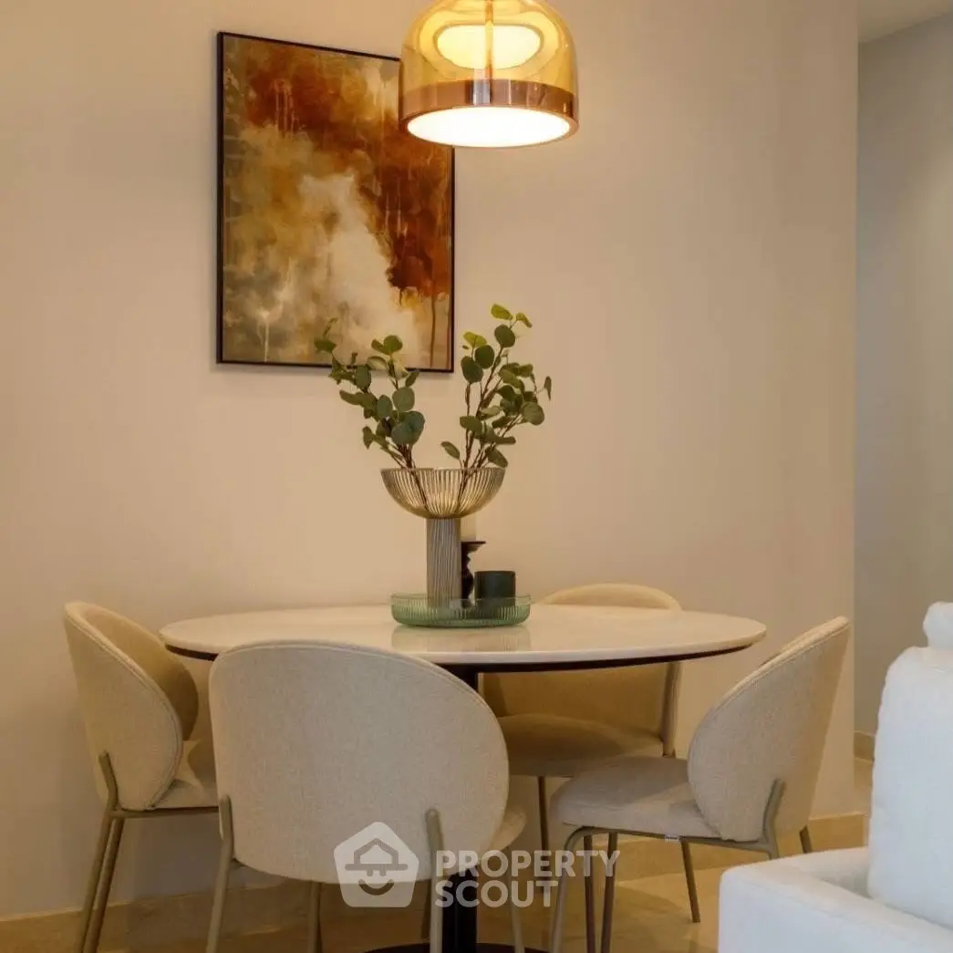 Elegant dining area with modern decor and stylish lighting in a cozy apartment.
