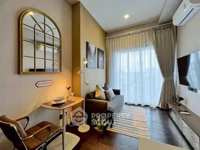 Modern living room with stylish decor, cozy seating, and large window for natural light.