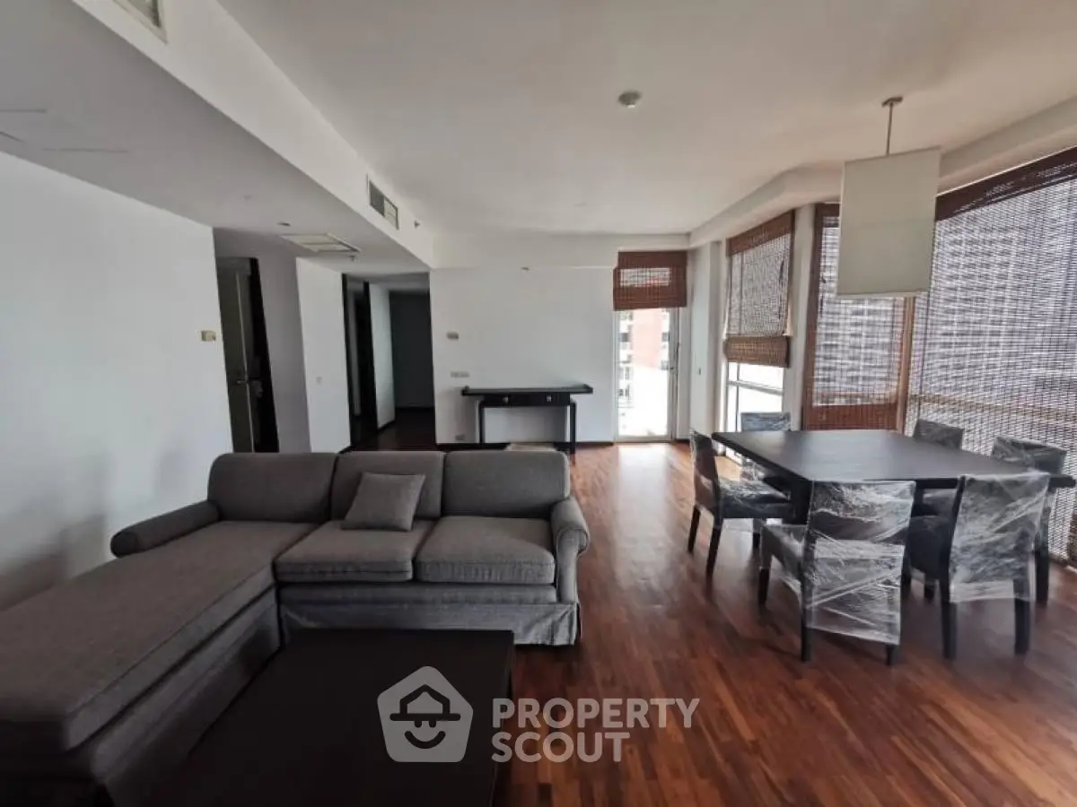 Spacious modern living room with wooden flooring and large windows