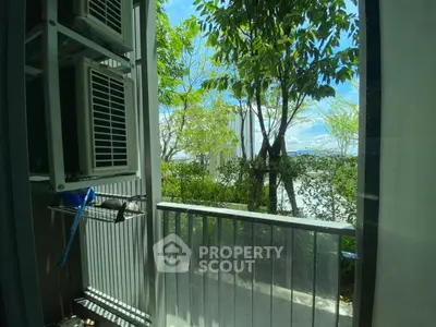 Charming balcony with lush greenery and city view, perfect for relaxation and enjoying nature.