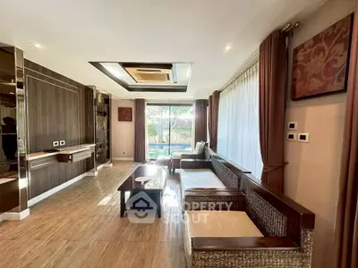 Spacious living room with modern decor and large windows offering natural light.