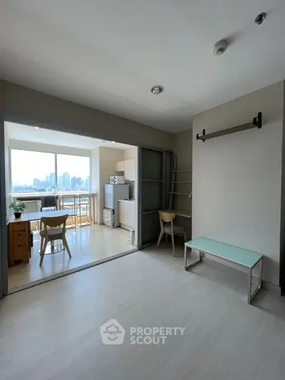 Spacious open-plan living area with city view, modern kitchen, and stylish furnishings.