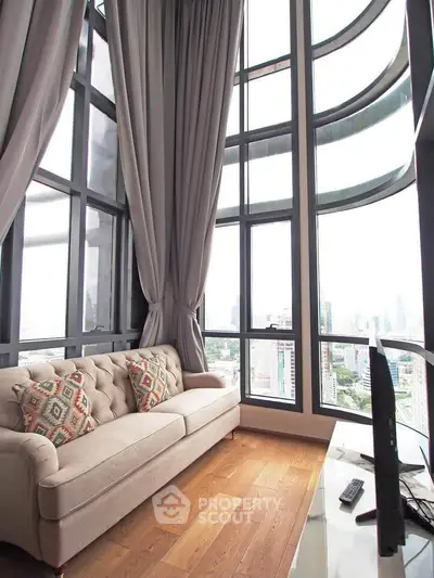 Luxurious high-rise living room with floor-to-ceiling windows and stunning city views.