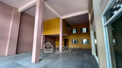 Spacious open area with high ceilings and modern architectural design, perfect for versatile use.