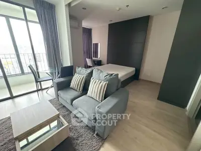 Modern studio apartment with open layout and balcony view