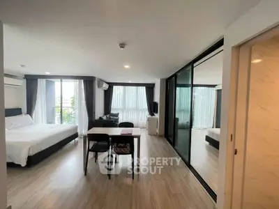 Spacious modern bedroom with large windows and elegant decor