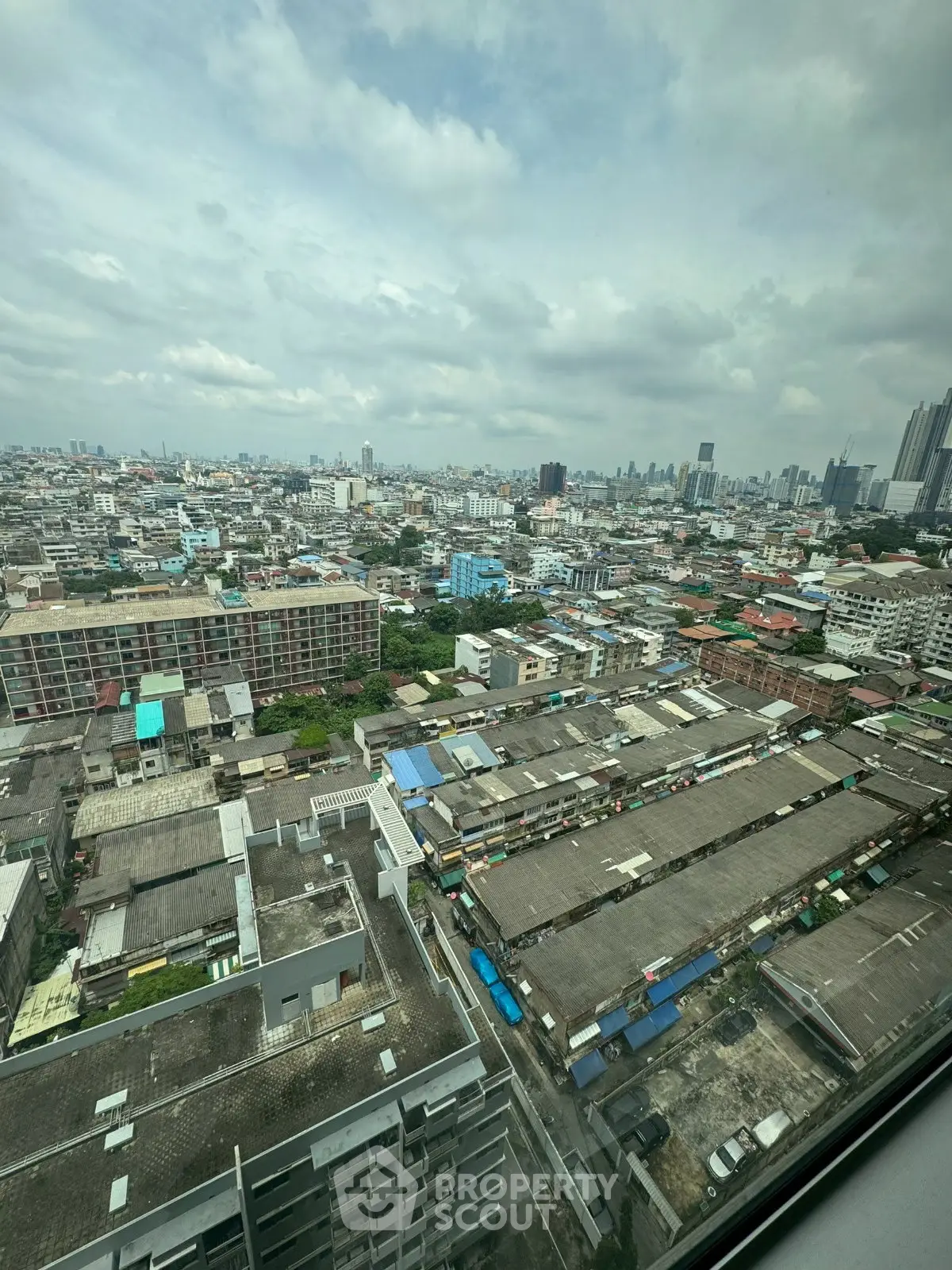 Stunning cityscape view from high-rise building showcasing urban skyline and architectural diversity.