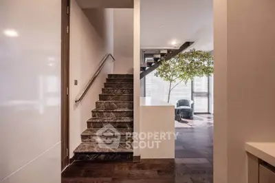 Modern interior with elegant staircase and cozy seating area