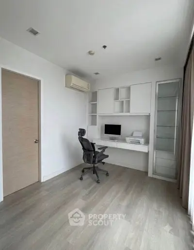 Modern study room with built-in desk, ergonomic chair, and ample storage in a bright, minimalist design.