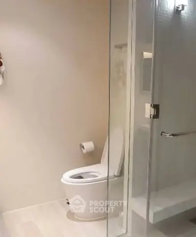 Modern bathroom with glass shower and sleek toilet design