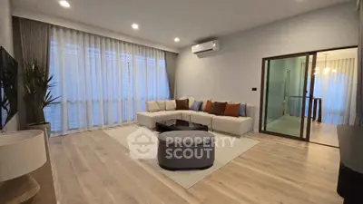 Spacious modern living room with elegant decor and large windows
