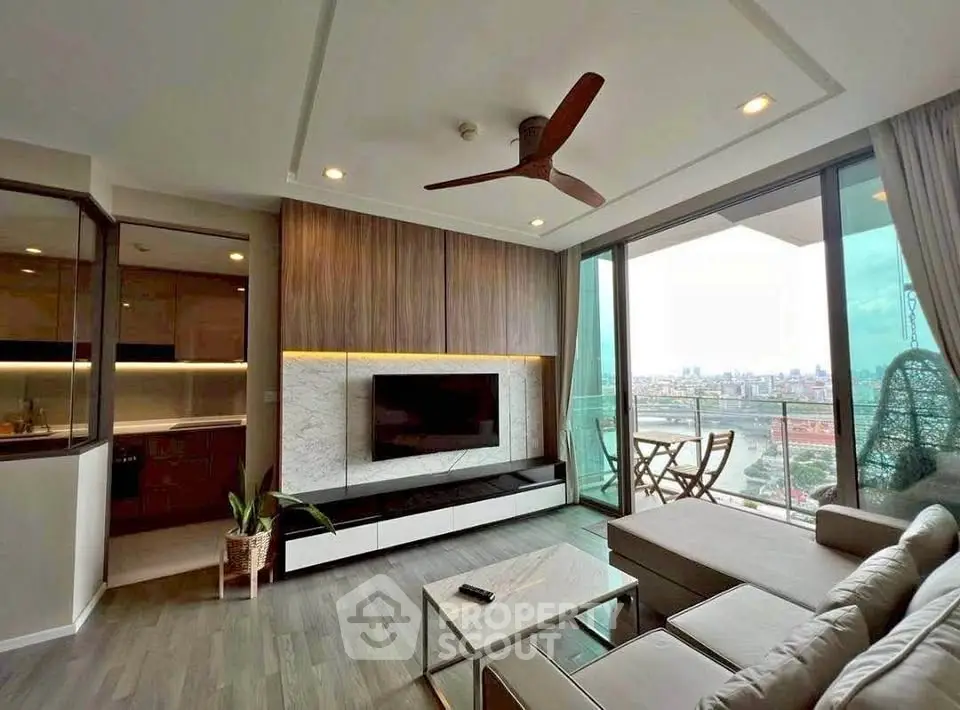 Modern living room with large windows and city view, featuring stylish decor and open layout.