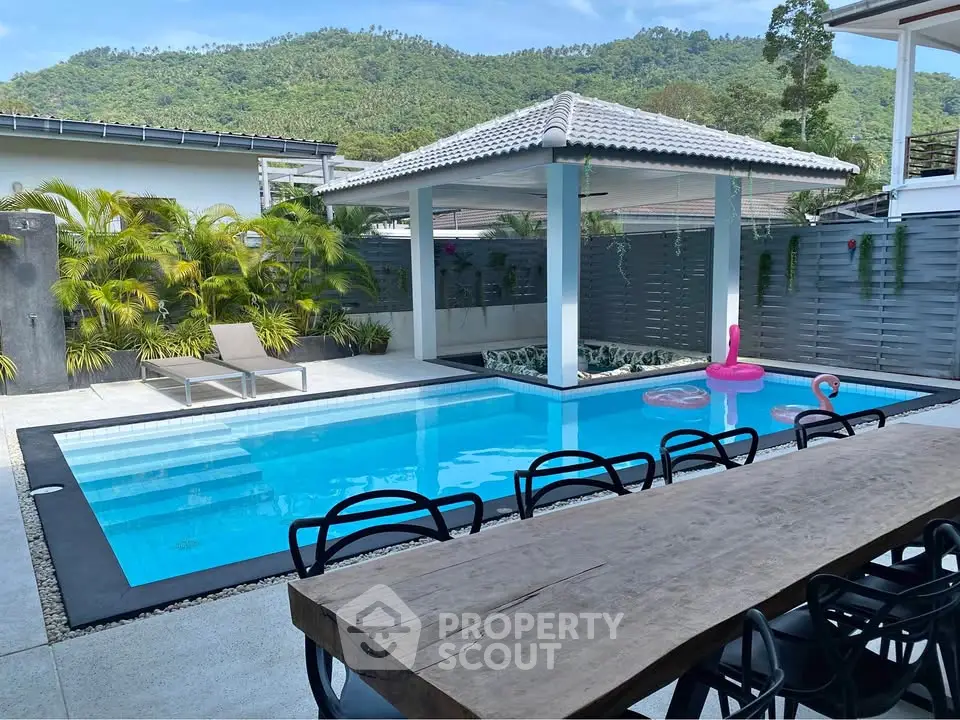 Luxurious outdoor pool area with mountain views and stylish seating, perfect for relaxation and entertainment.