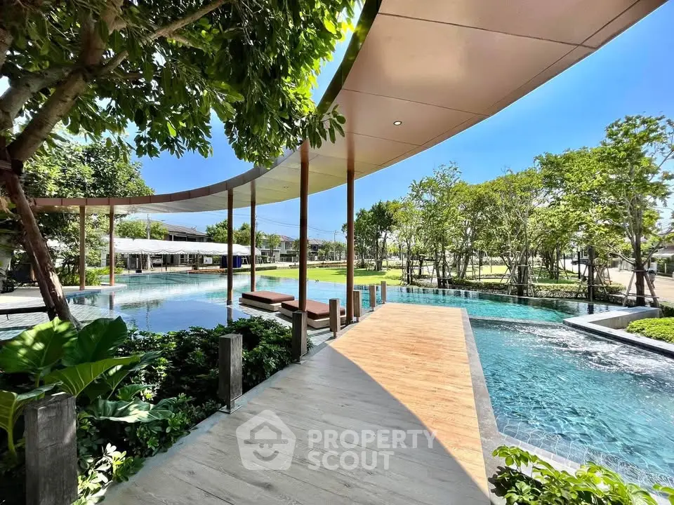 Luxurious outdoor pool area with lush greenery and modern design, perfect for relaxation and leisure.