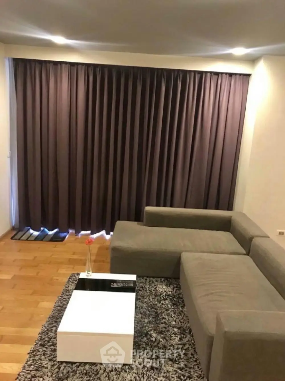 Modern living room with stylish sofa and elegant curtains, perfect for cozy evenings.