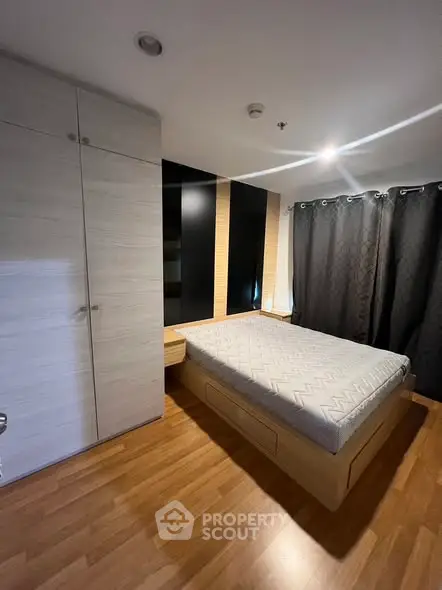 Modern bedroom with sleek design and wooden flooring