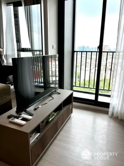 Modern living room with city view and sleek balcony access