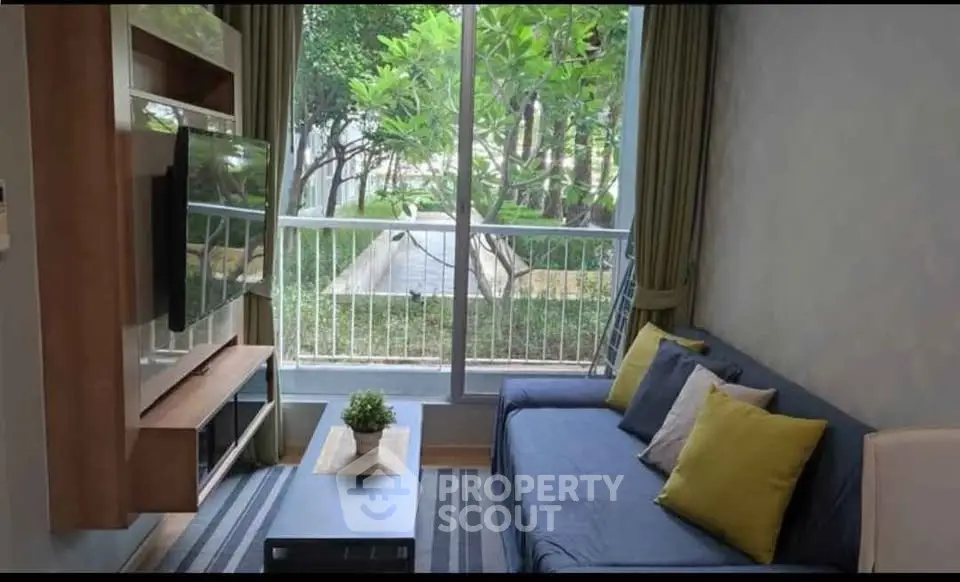Cozy living room with garden view, modern decor, and natural light.