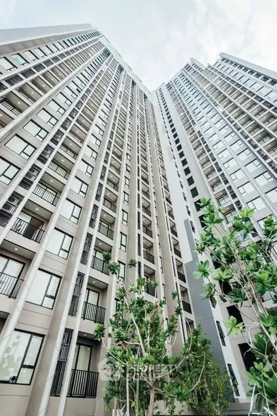 Stunning high-rise building exterior with modern architecture and lush greenery.