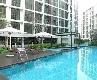 Luxurious apartment complex with a stunning outdoor pool and modern amenities.