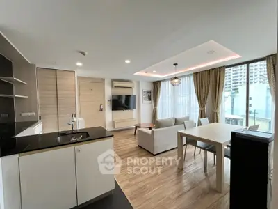 Modern open-plan living room with stylish kitchen and large windows