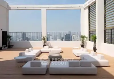 Luxurious rooftop terrace with modern seating and stunning city views, perfect for relaxation and entertainment.