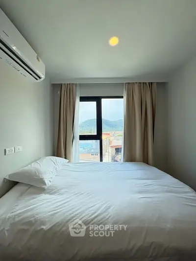 Cozy bedroom with mountain view and natural light