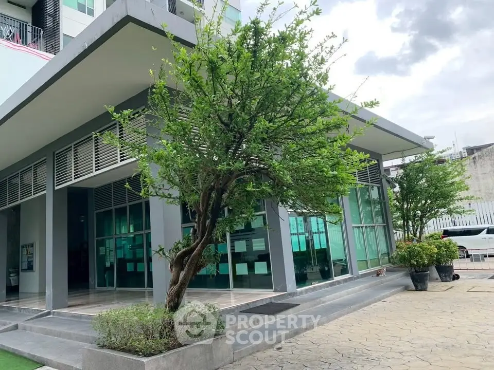 Modern building exterior with lush greenery and sleek design