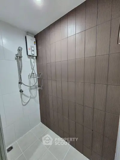 Modern bathroom with sleek shower and stylish brown accent wall