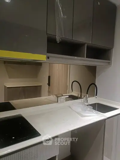 Modern kitchen with sleek cabinetry and dual stovetops, perfect for culinary enthusiasts.