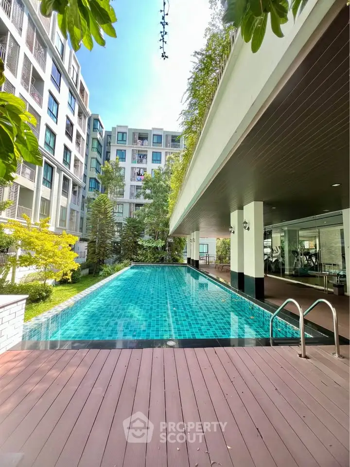 Luxurious condominium with stunning pool and lush greenery, perfect for relaxation and leisure.