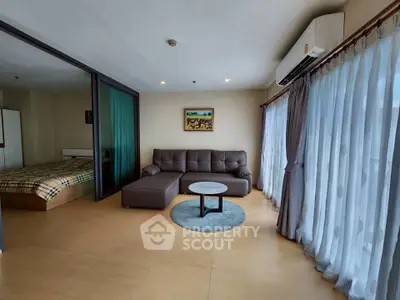 Spacious living room with modern sofa and large windows in a stylish apartment