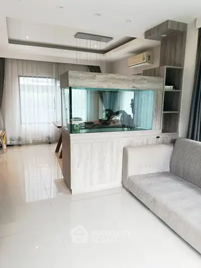 Modern living room with large aquarium and stylish decor