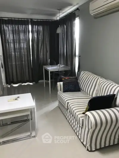 Cozy living room with striped sofa and modern decor, perfect for relaxation.