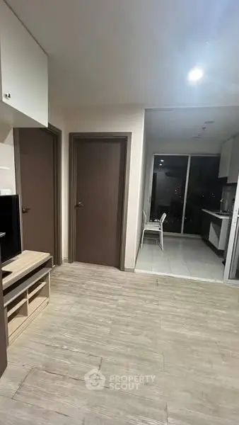 Modern apartment interior with open layout and sleek kitchen design.
