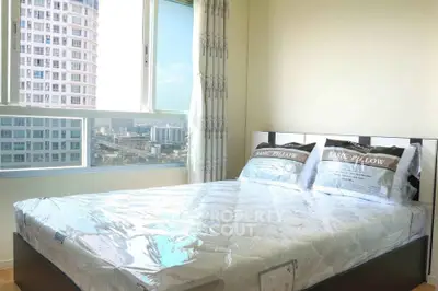 Bright bedroom with city view and modern furnishings