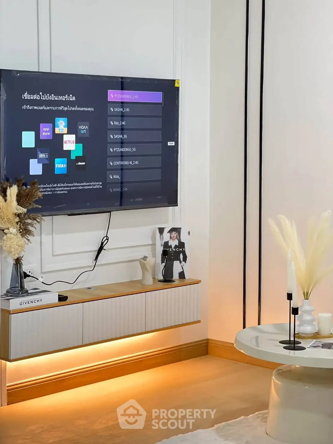 Modern living room with wall-mounted TV and stylish decor