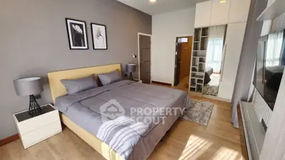 Modern bedroom with stylish decor and ample natural light