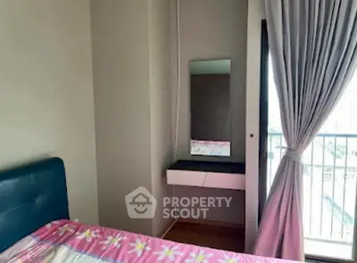 Cozy bedroom with balcony access and stylish decor in modern apartment.