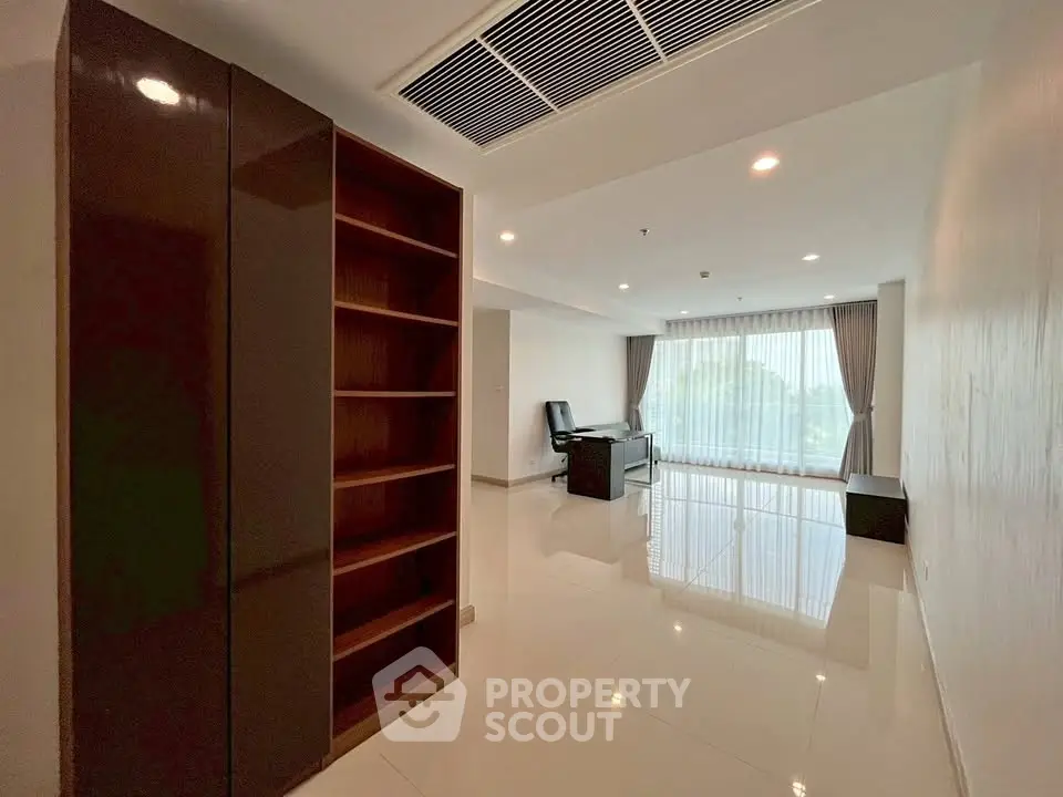 Spacious modern living room with large windows and sleek furniture