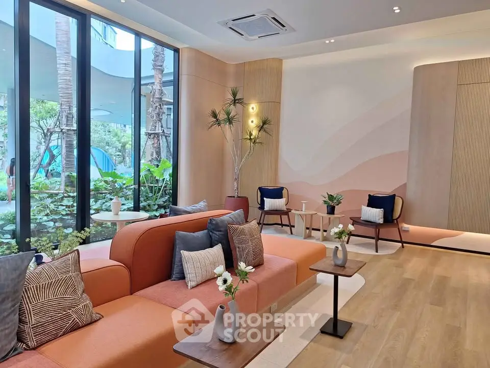 Modern living room with stylish decor and large windows overlooking lush garden