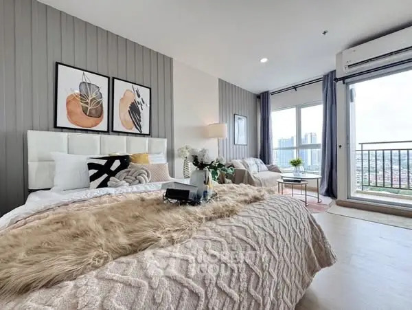 Luxurious bedroom with modern decor and stunning city view from balcony.