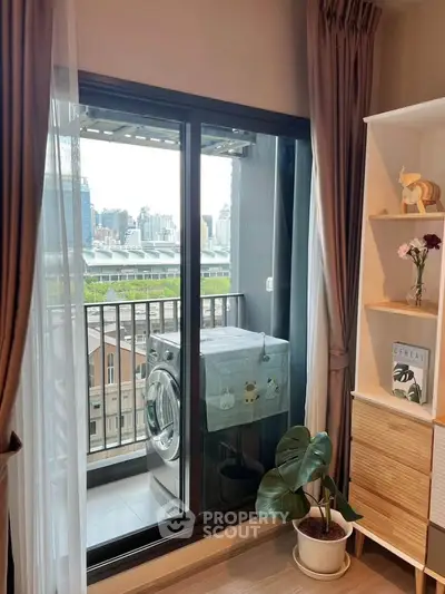 Chic apartment with balcony view and modern laundry setup, perfect for urban living.