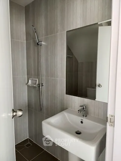 Modern bathroom with sleek sink and shower in minimalist design